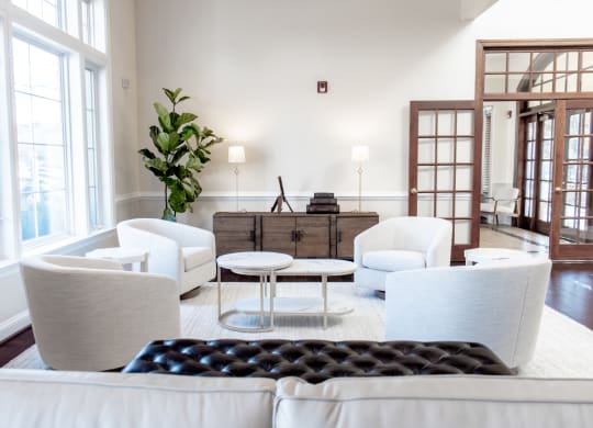 a living room with white furniture and large windows at Broadlands Apartments, 20148